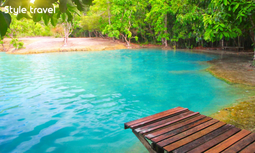 Emerald-green water surrounded by forest at the Emerald Pool in Krabi