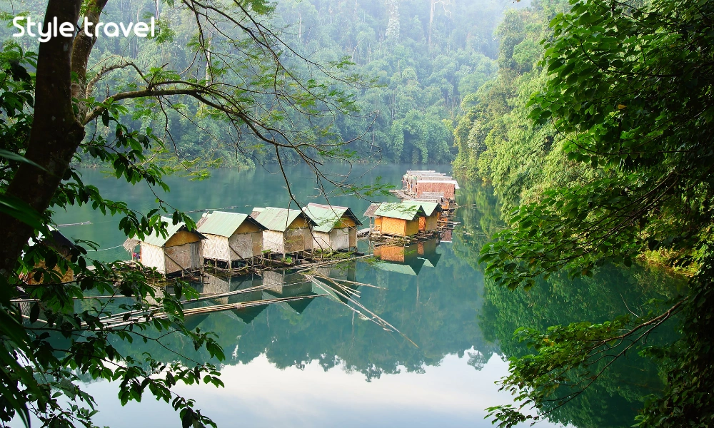 Floating bungalows beneath limestone cliffs on Cheow Lan Lake