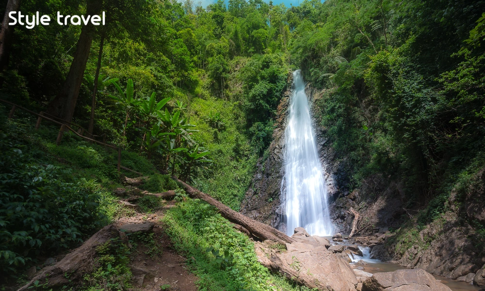 Khun Korn Waterfall dropping into a forested ravine in Chiang Rai