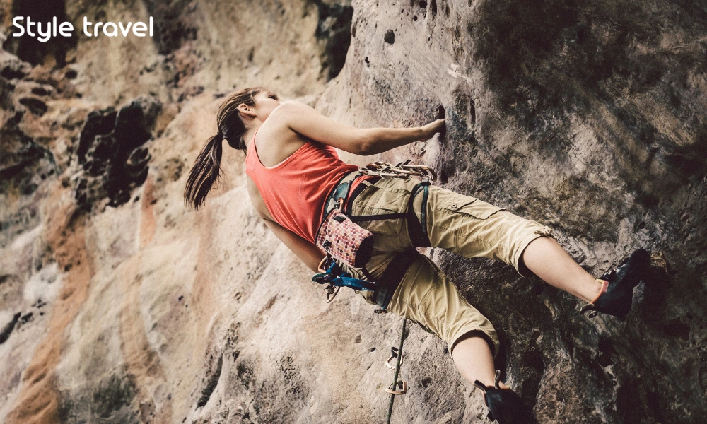 Rock climber using ropes on a limestone cliff at Railay