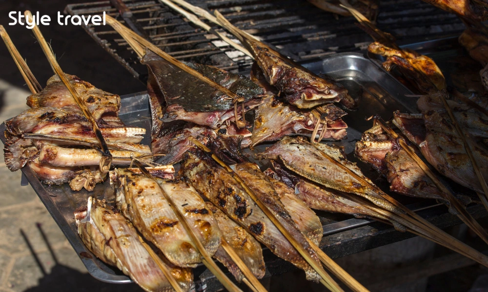 Salt-crusted fish grilling at Khlong Lat Mayom Floating Market