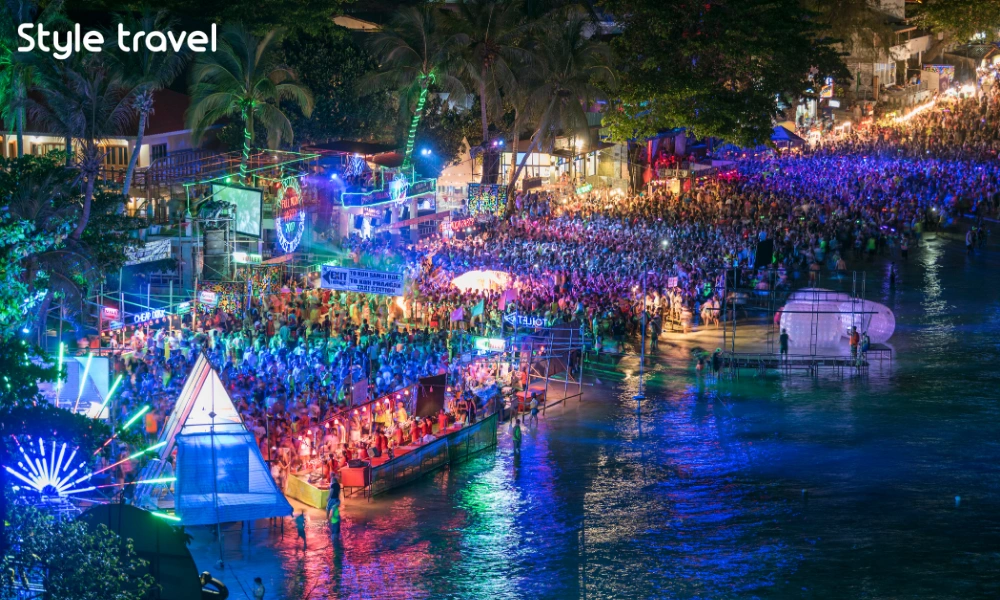 Full Moon Party crowds on Haad Rin Beach during nightlife in Thailand