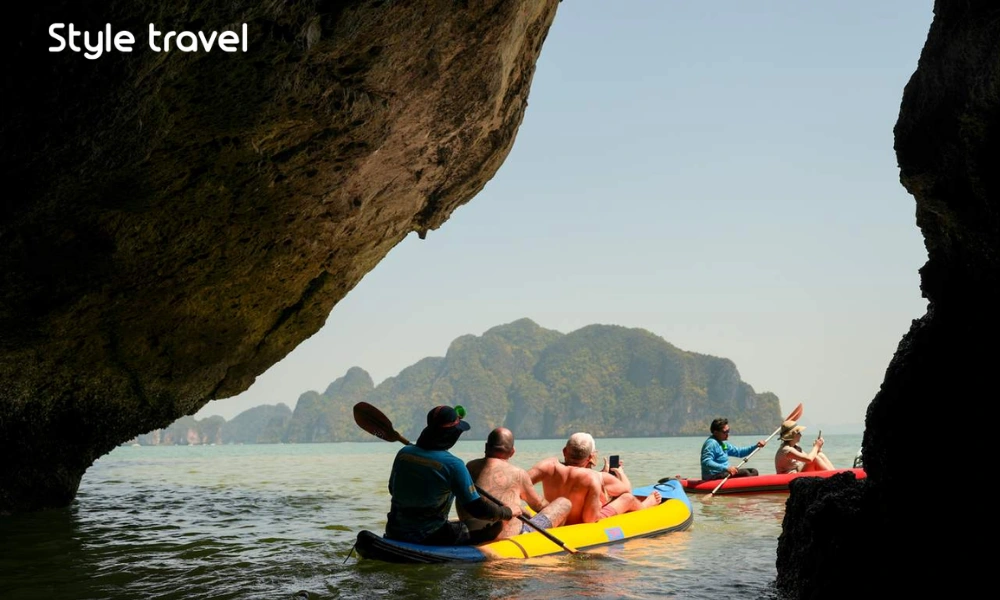 Guided canoe beside limestone cliffs in Phang Nga Bay