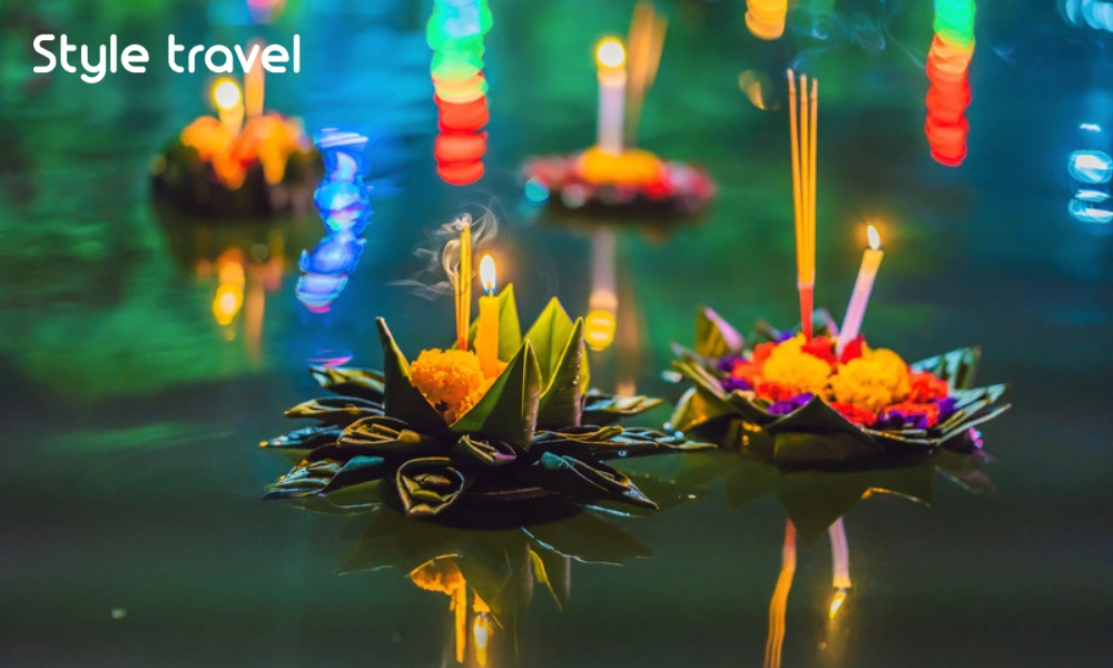 Candlelit krathong decorated with flowers for Loy Krathong in Thailand